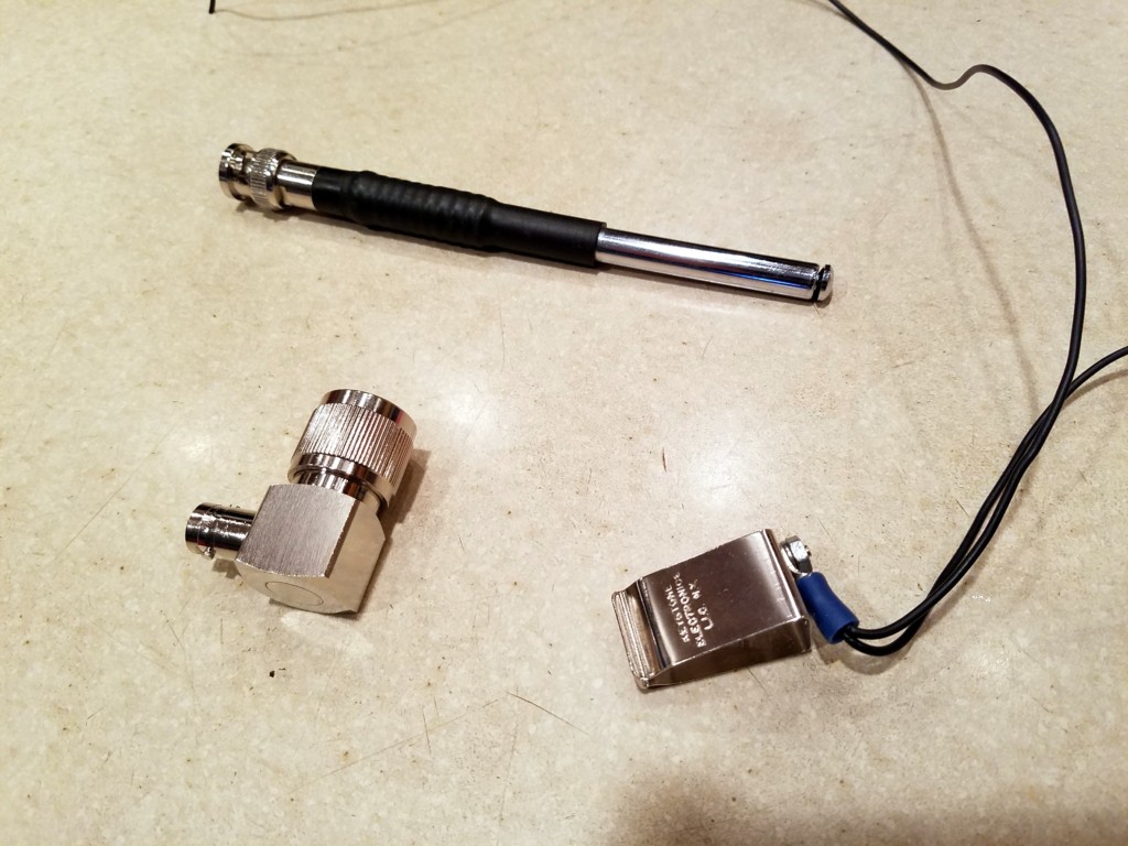 Quickie Whip Antenna components: telescopic whip antenna, PL-259 to BNC-F right-angle adapter, and the modified 9V battery clip for the counterpoise wires.