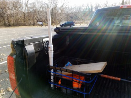 My makeshift mount. The PVC mount is attached to the plastic crate, while the crate is attached to a cargo bar using bungee cords. The random junk I store in the crate keeps things stable.