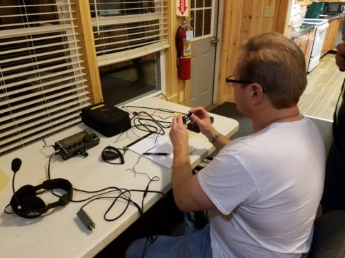 Ron WA8YIH inspecting the QRPver transceiver he won as a door prize.