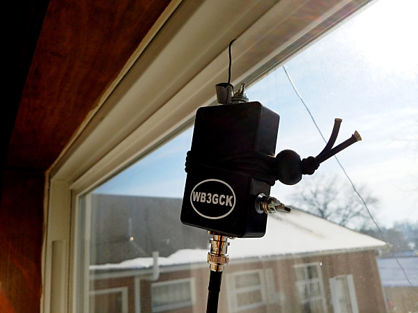 My impromptu sloper's feedpoint. The wire from the 9:1 UNUN is just pinched in the window.