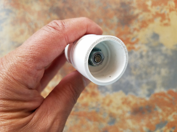 Stainless steel rod bolted through the two back-to-back PVC end caps