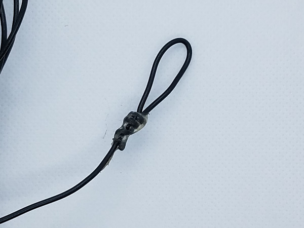 End loop on one of my (many) wire antennas for portable use. I attach my throwing line directly to the loop, foregoing an insulator. With smaller diameter wire, I sometimes put some shrink wrap over the GOOP.