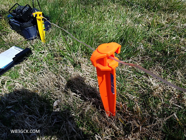 I used a couple of large tent stakes to keep the balanced feedline portion of the antenna off the ground.