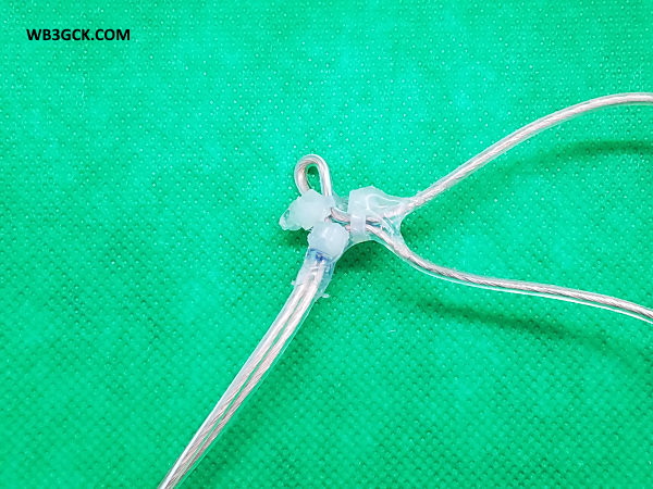 Example attachment point. This is the feedpoint of the antenna. The two wires to the right are part of the loop antenna, while the wires towards the bottom serve as the balanced feedline. I used some Goop® adhesive on the zip-ties to help hold them in place.