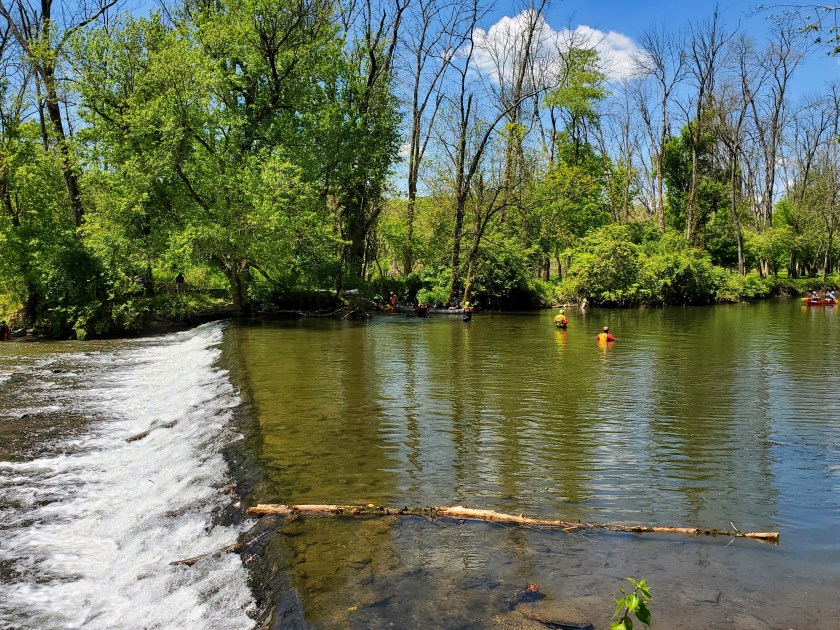 The dam on the Brandywine River. Members of a water rescue team were in the water directing canoeists around the dam.