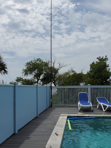 My 31-foot Jackite pole strapped to a fence about 40 feet away from the house