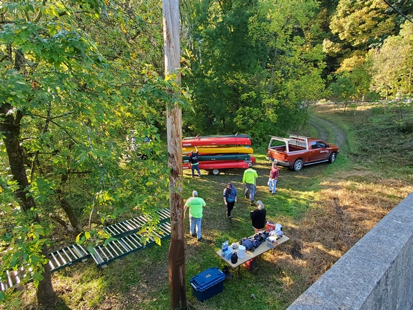The boat handlers getting a load of canoes ready to go back upriver. They use a system of rollers to help move the canoes up from the river.