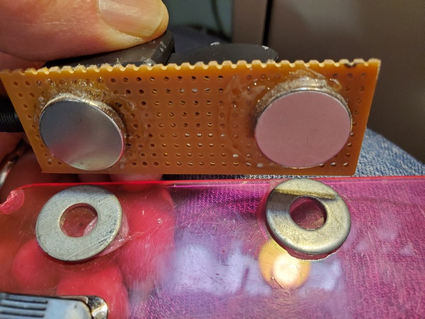 Magnets glued to the underside of the perf board to line up with the steel washers on my clipboard