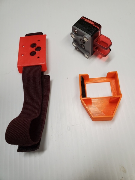 The Ashi Paddle 45 leg mount (left), the paddles with the magnetic mount attached (upper right), and the protective case for the paddles.