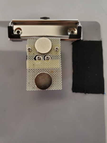 The underside of my quick and dirty mod. The black rectangle to the right are the steel strips covered with hockey grip tape.